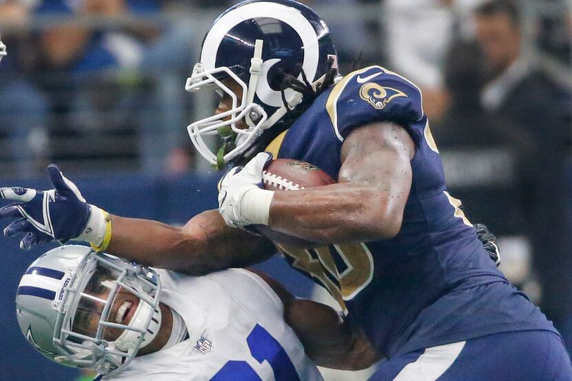 Dallas Cowboys free safety Byron Jones (31) takes a forearm from Los Angeles Rams running...