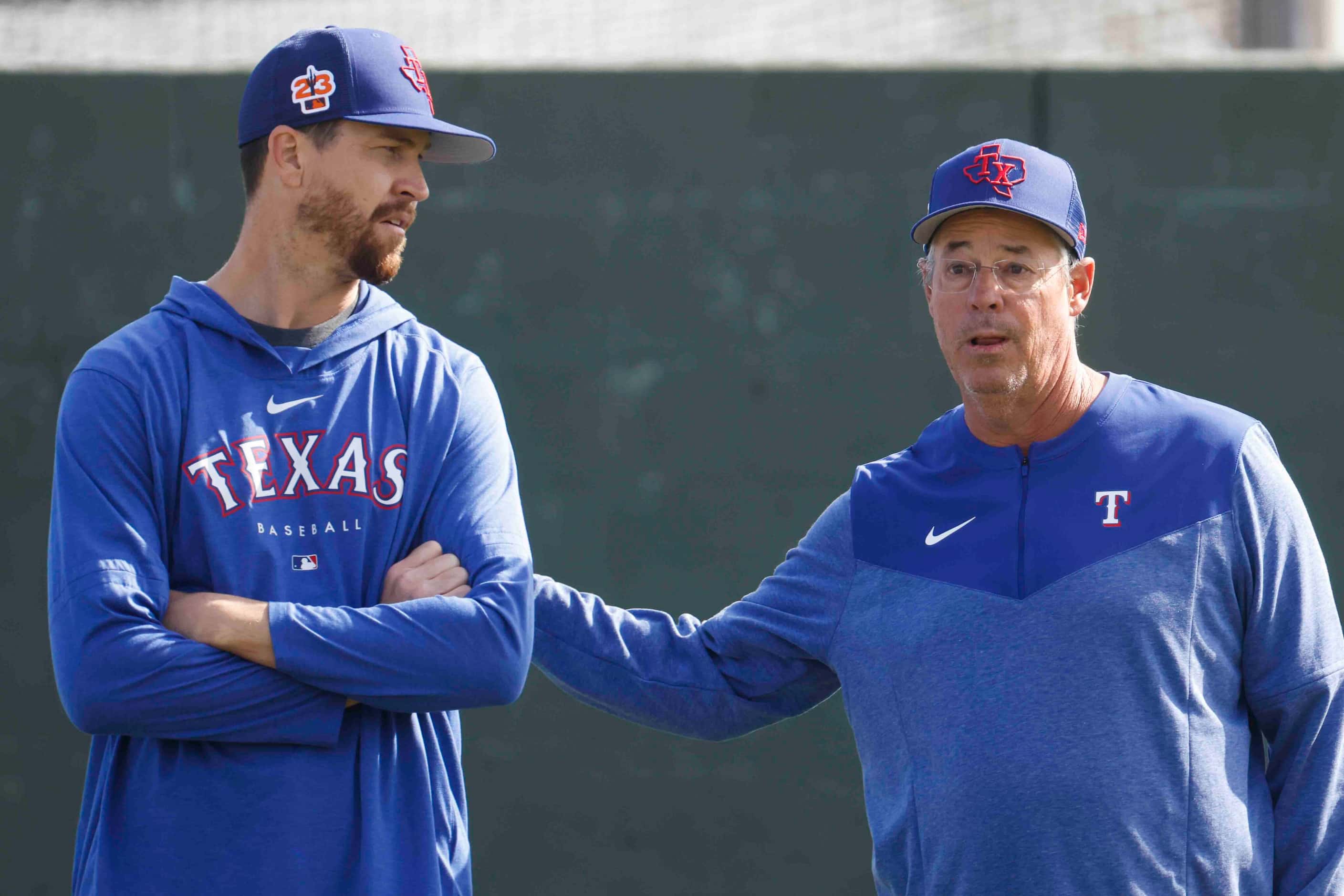Texas Rangers pitcher Jacob deGrom, left, talks to special assistant Greg Maddux during a...