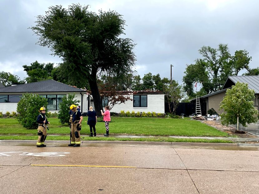 Residents along the 7700 block of Northaven Road in North Dallas react and console each...