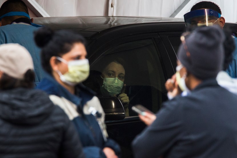 A woman tried to get a nurse's attention at the drive-through testing site at American...