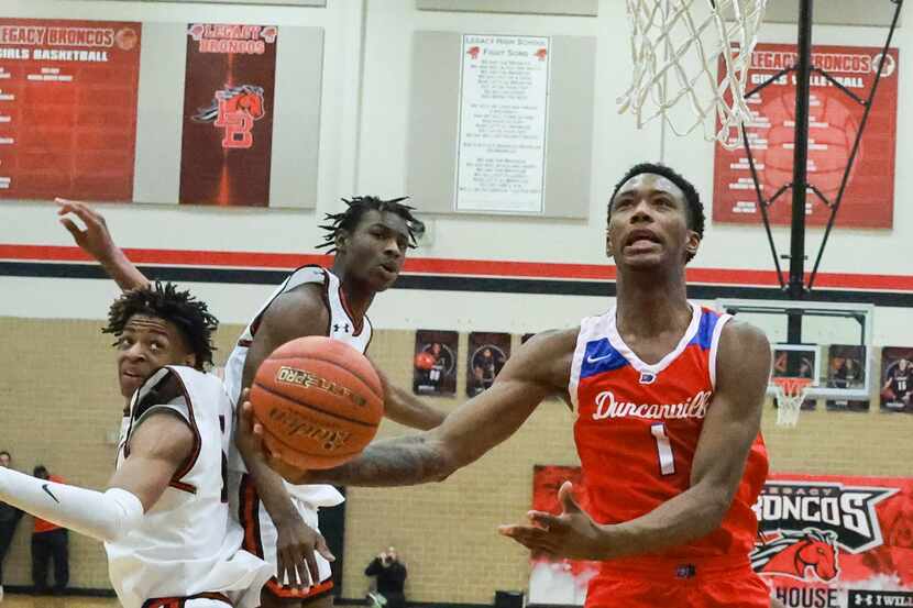 Duncanville High School’s Ron Holland (1) jumps past  Mansfield Legacy High School’s Ahmare...