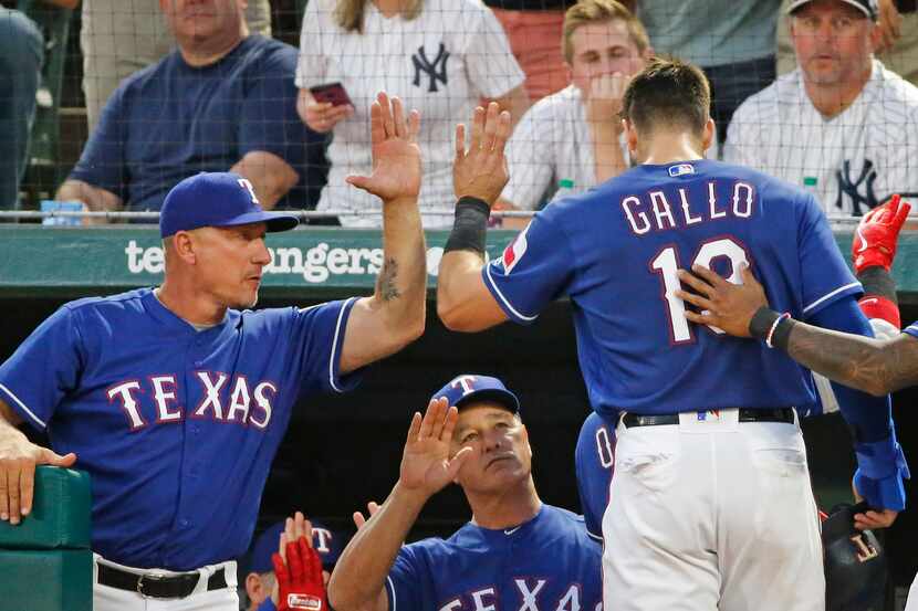 Texas Rangers manager Jeff Banister (28) congratulates Texas Rangers left fielder Joey Gallo...