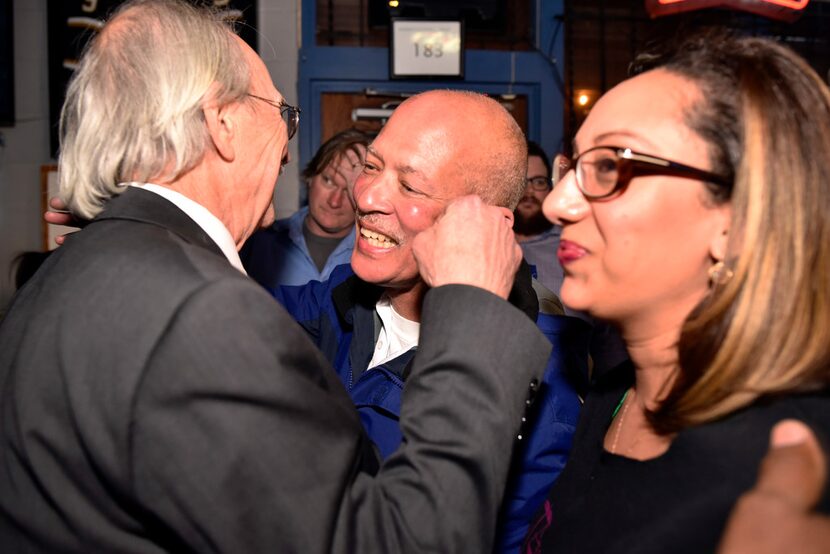 Candidate for Dallas district attorney John Creuzot is congratulated as he enters an...