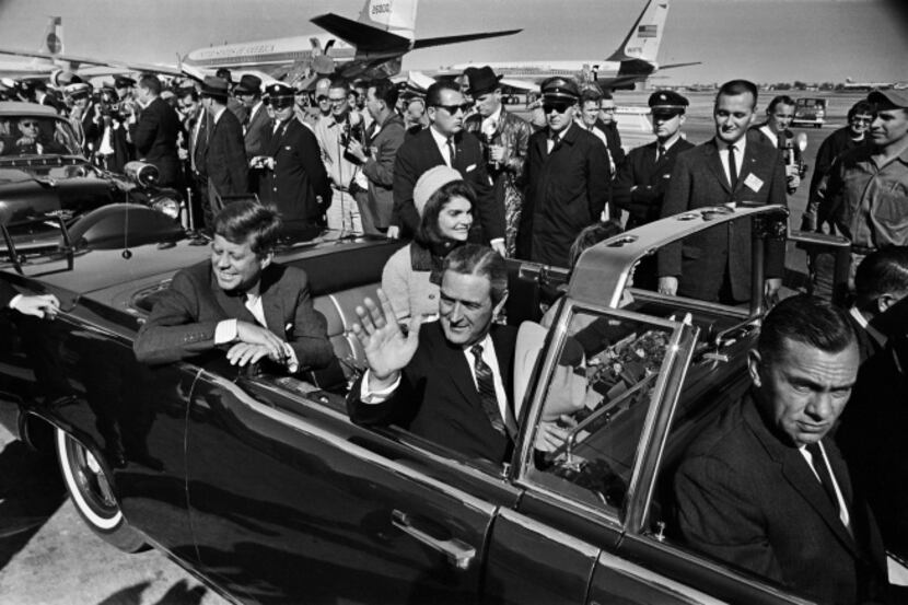 President John F. Kennedy and Jacqueline Kennedy begin the motorcade from Love Field to...