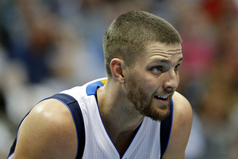 Dallas Mavericks forward Chandler Parsons talks to teammates on the free throw line during...