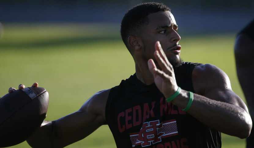 Quarterback Avery Davis runs through drills at Cedar Hill High School in Cedar Hill, Texas ...