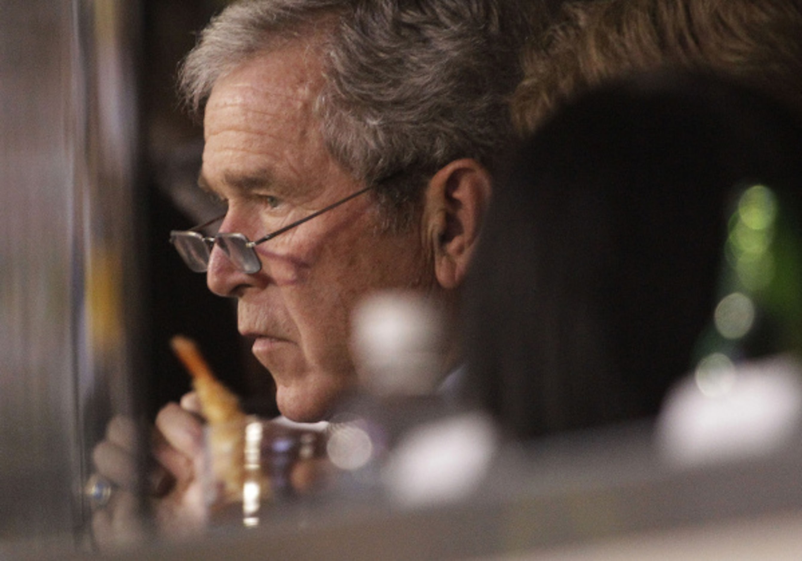 Former President George W. Bush watches the first half of the NFL football Super Bowl XLV...