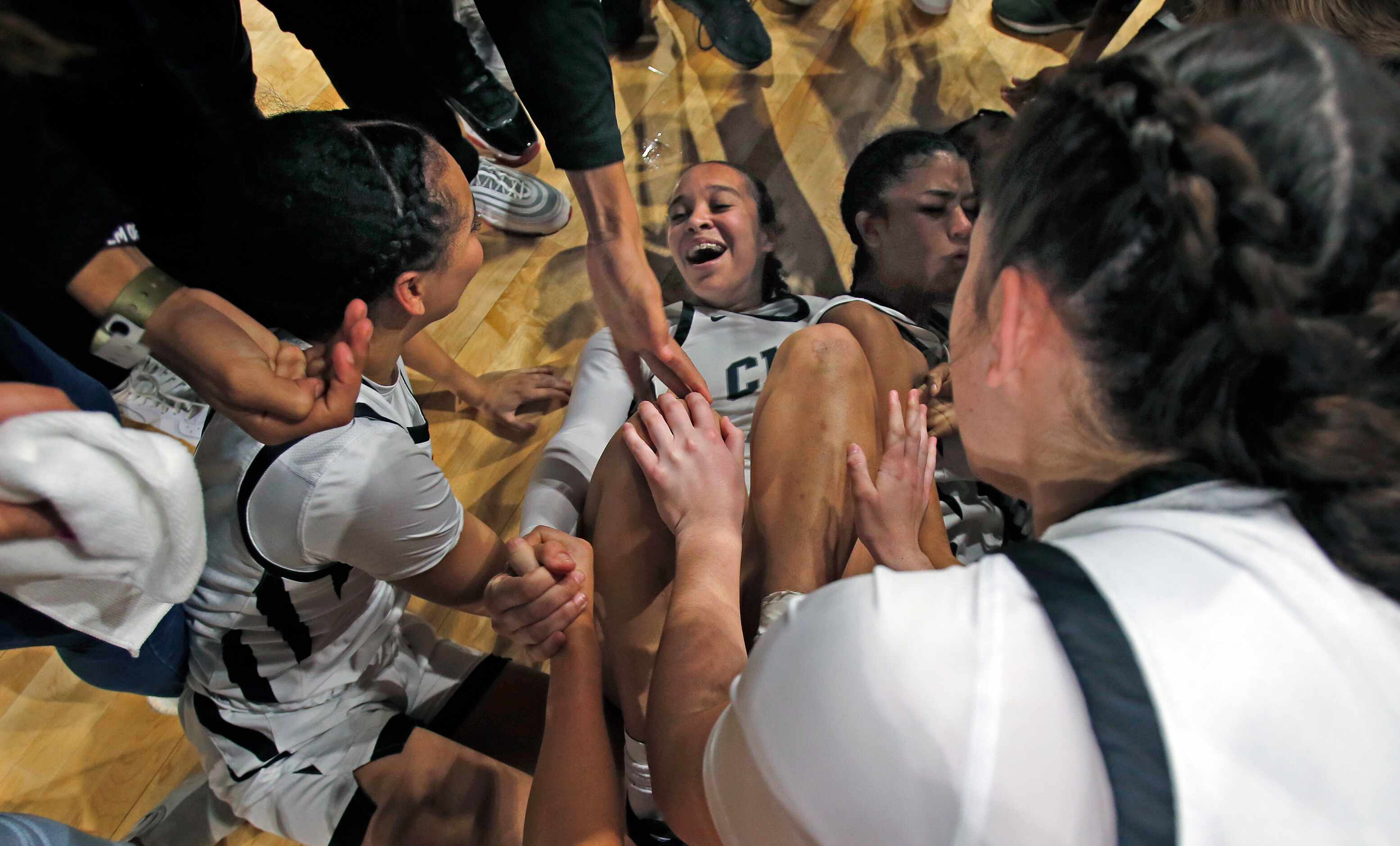 Clark celebrated on the floor after they defeated DeSoto 42-37 in girls basketball Class 6A...