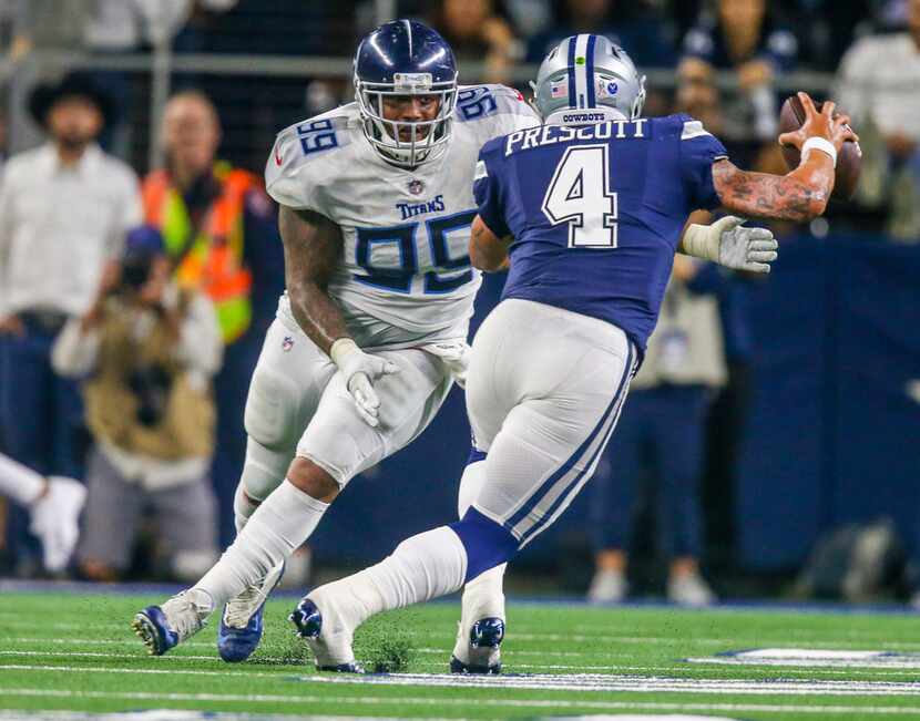 Dallas Cowboys quarterback Dak Prescott (4) attempts to escape a Tennessee Titans defensive...
