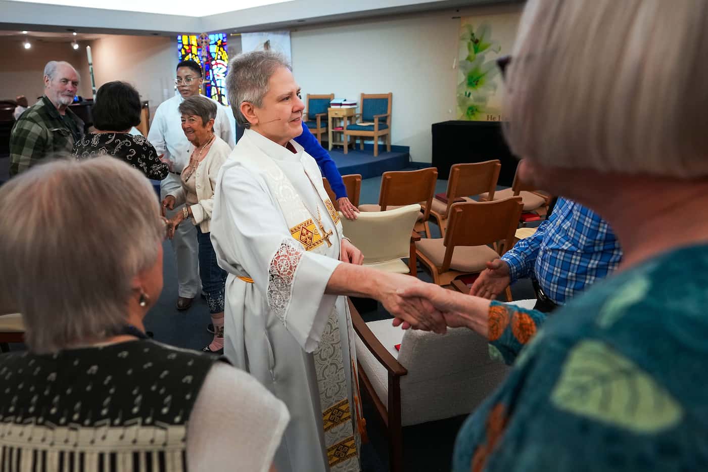 Rev. Jane Graner greets members of her congregation during services at Trinity United...
