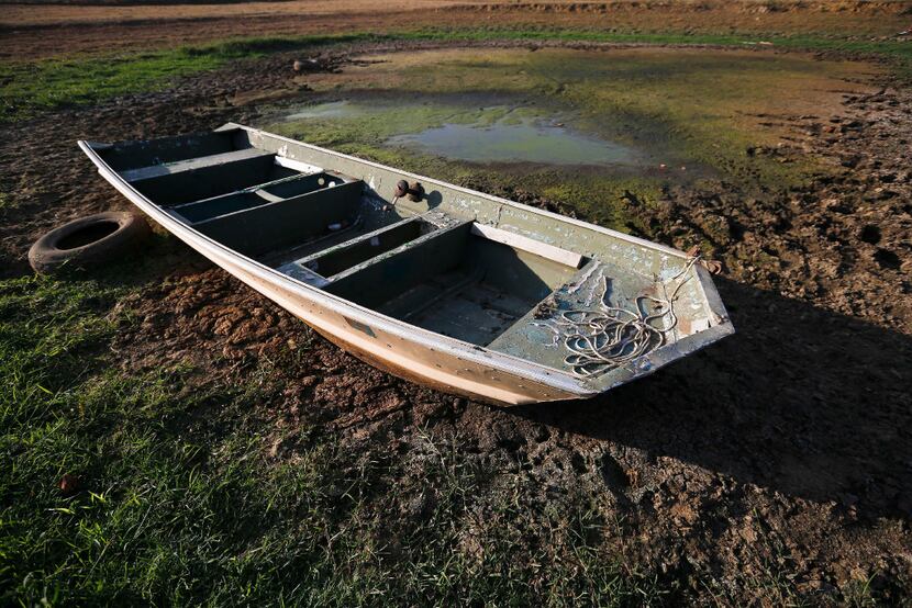 An abandoned boat sits in the remains of a dried-out pond  in Dawson, Ala.  (Brynn...