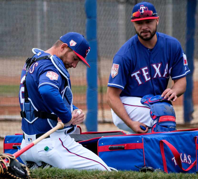Texas Rangers catchers Isiah Kiner-Falefa (right) and Jeff Mathis prepare to catch a bullpen...