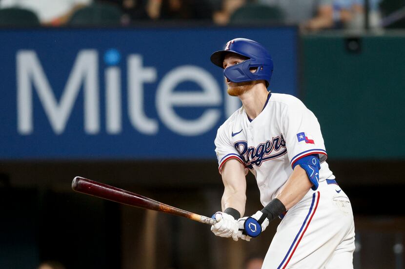 Texas Rangers catcher Sam Huff (55) watches the ball after hitting a home run to left field...