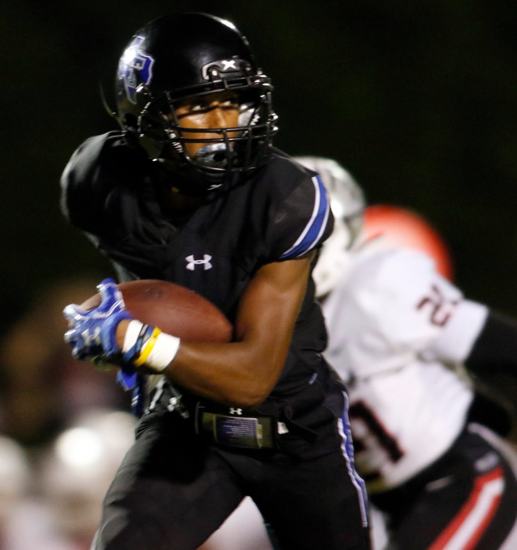 Trinity Christian Cedar Hill receiver CJ Thompson (3) glances over his shoulder as he races...