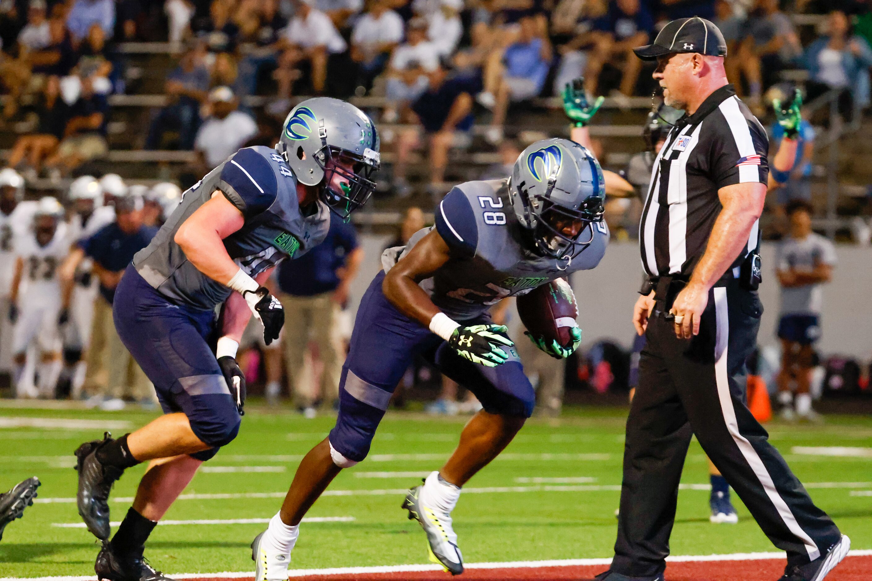 V.R. Eaton High School running back De’Marion Williams-Franklin (28) reaches the end zone...