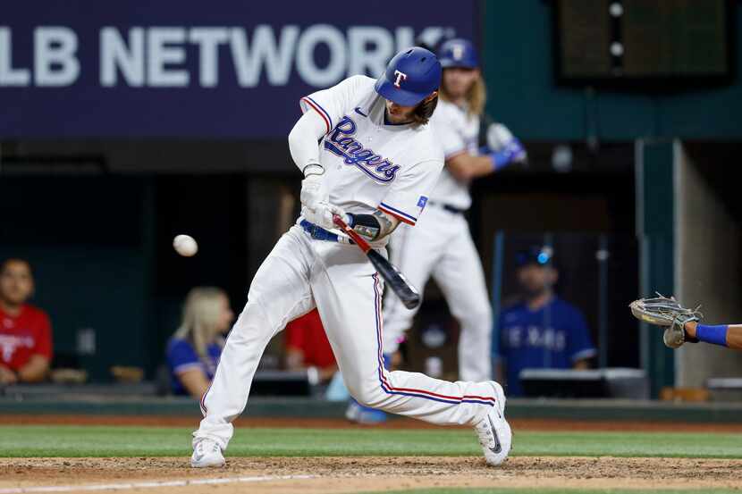 Texas Rangers catcher Jonah Heim (28) hits a walk-off three-run home run during the 10th...
