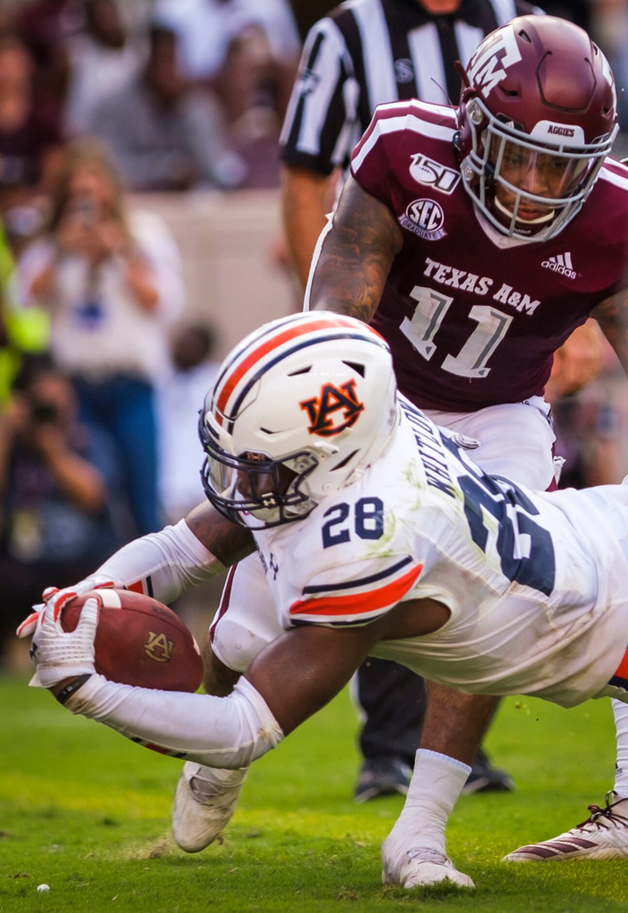 Auburn running back JaTarvious Whitlow (28) dives into the end zone past Texas A&M defensive...