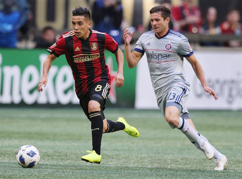 Atlanta United midfielder Ezequiel Barco works past Chicago Fire midfielder Brandt Bronico...