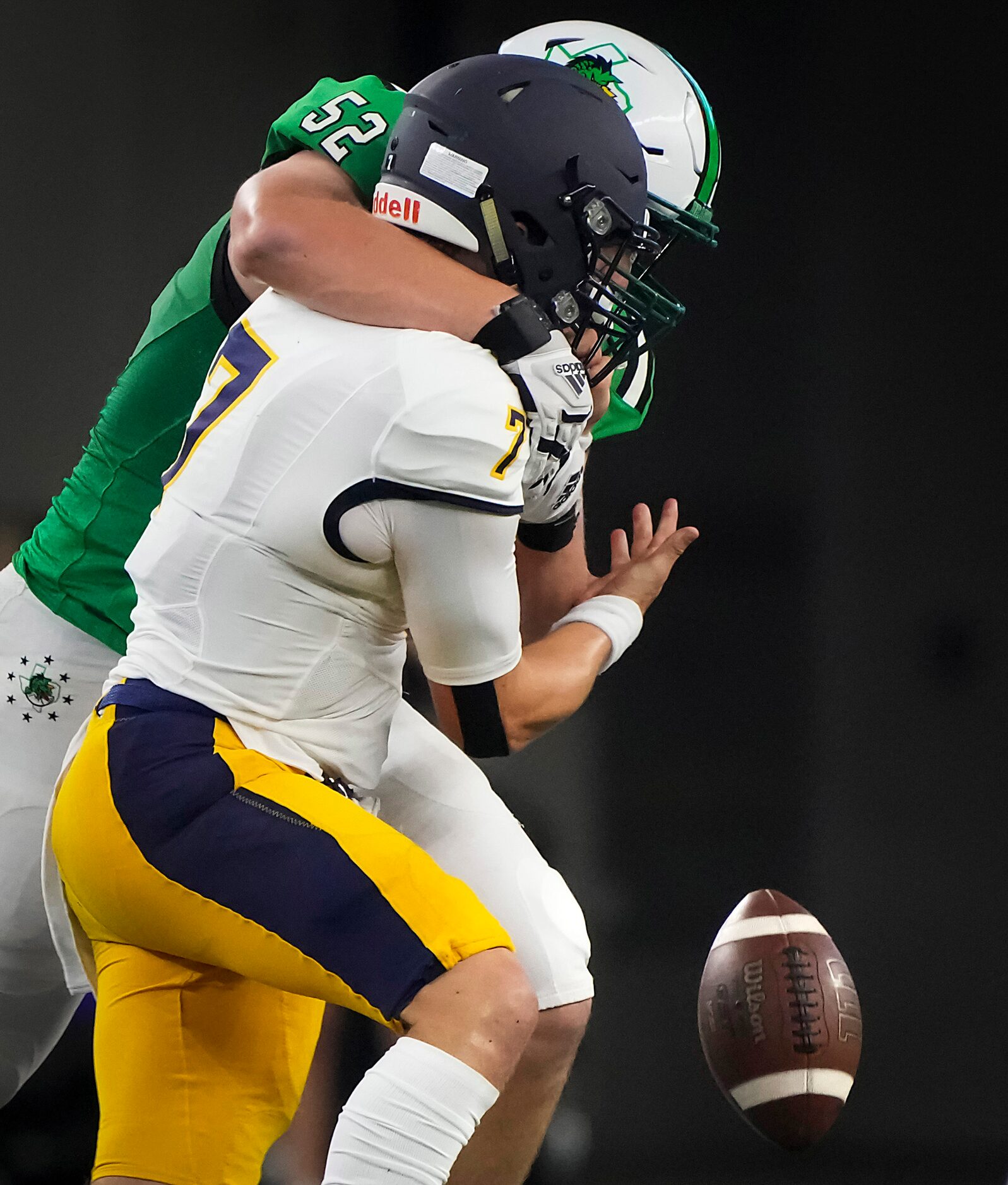 Highland Park quarterback  Brennan Storer (7) fumbles as he is hit by  Southlake Carroll...