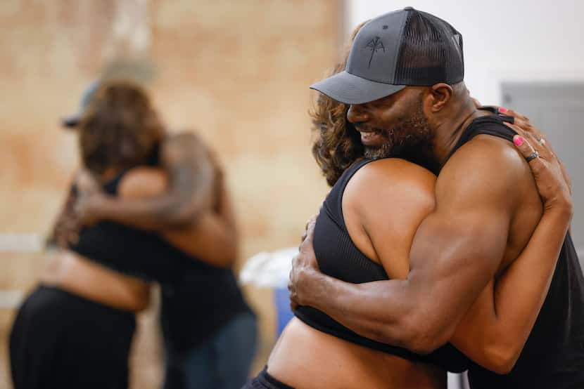 Instructor Cassandra Young (left) shared a hug with Fredrick Robinson of Grand Prairie ahead...
