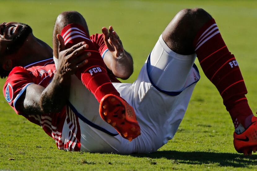 FC Dallas midfielder Kellyn Acosta (23) reacts after tripping in a collision with Los...
