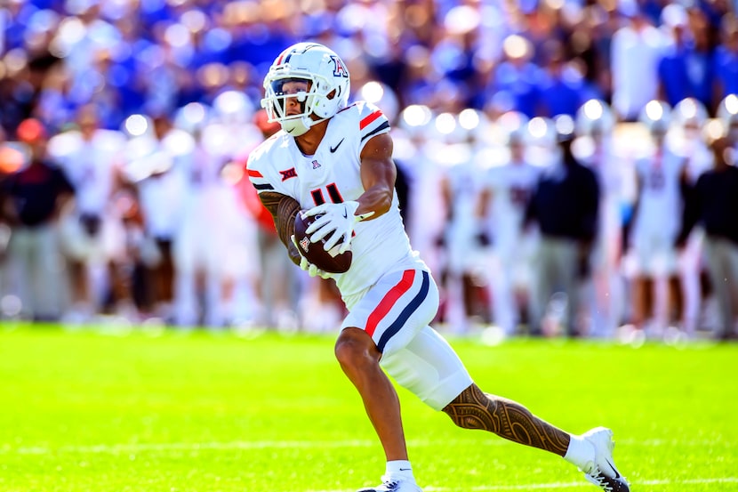 Arizona wide receiver Tetairoa McMillan makes the catch for a first down during an NCAA...