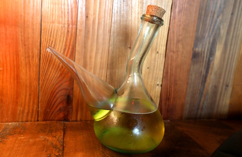 A carafe of wine called The Porron could go fast if you use it like it's intended: Tip the...