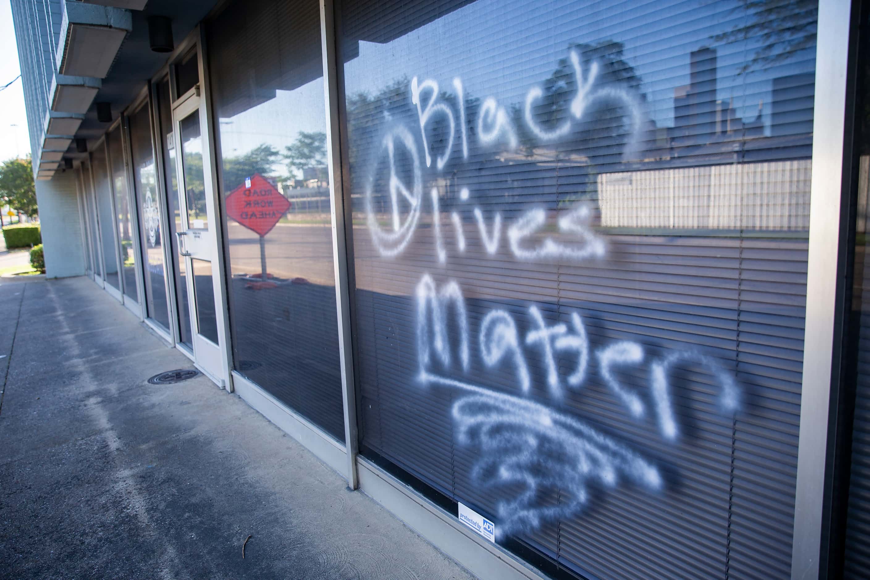 Graffiti left at the Dallas Police Association office during last night's protest, seen...