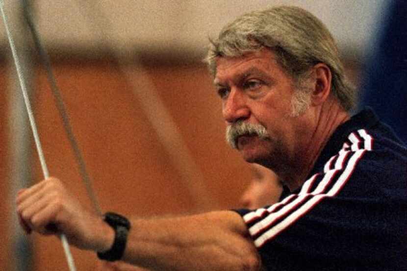 In the spring of 2000, Bela Karolyi watched over U.S. Olympic gymnastics team members as...