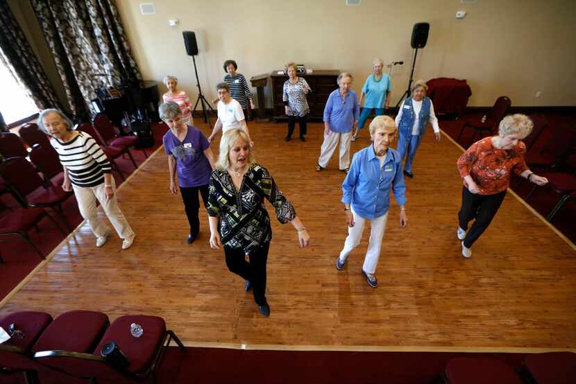 Cyndi Dorber (center) leads a line dancing class for seniors at Atria Canyon Creek in Plano.