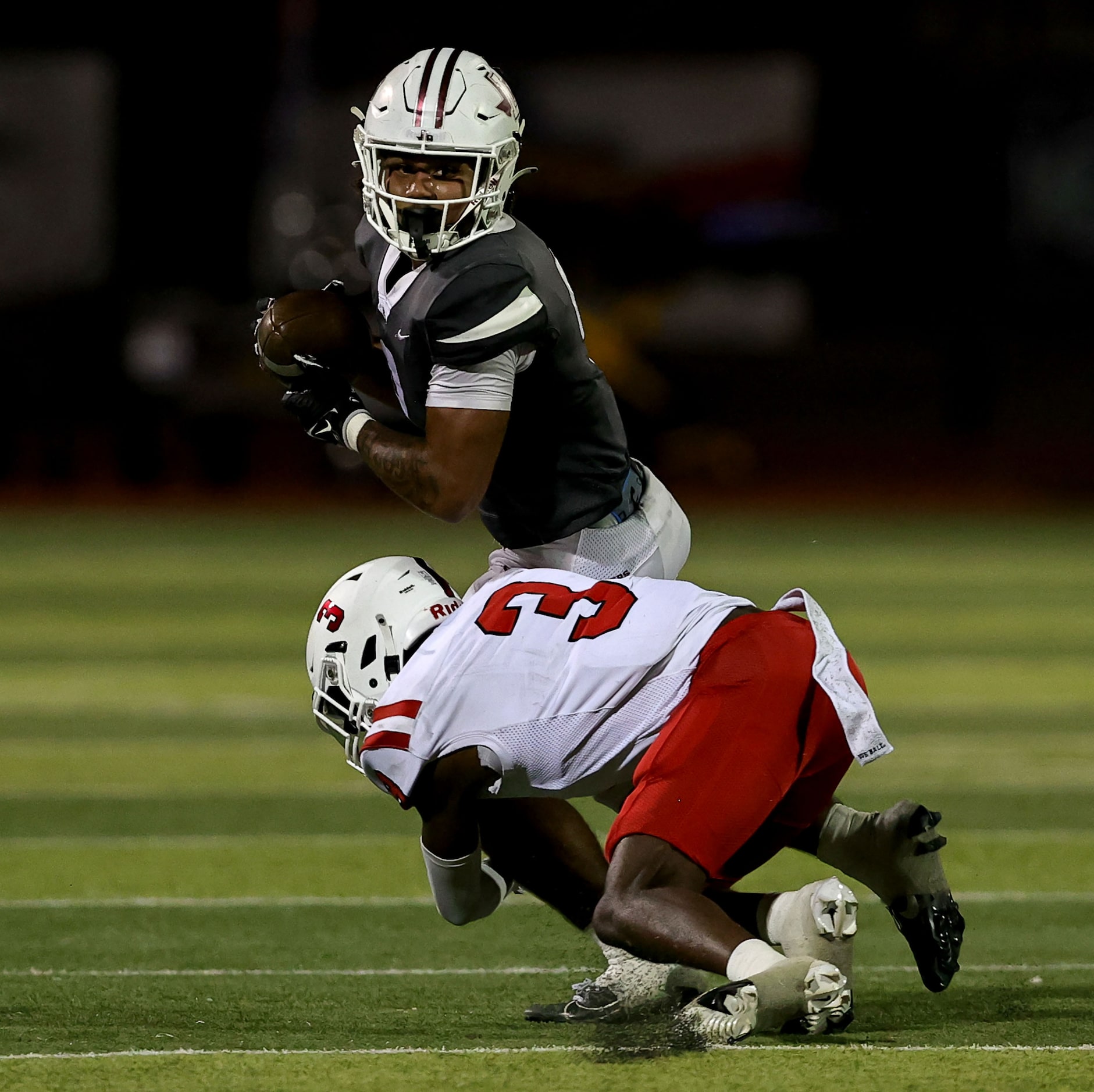 Lewisville running back Tenel Hill (9) gets tackled by Coppell cornerback Seth Carethers (3)...