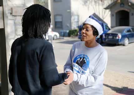Aris Joseph greets the Dallas police chief during a Santa Cops toy giveaway at his home....