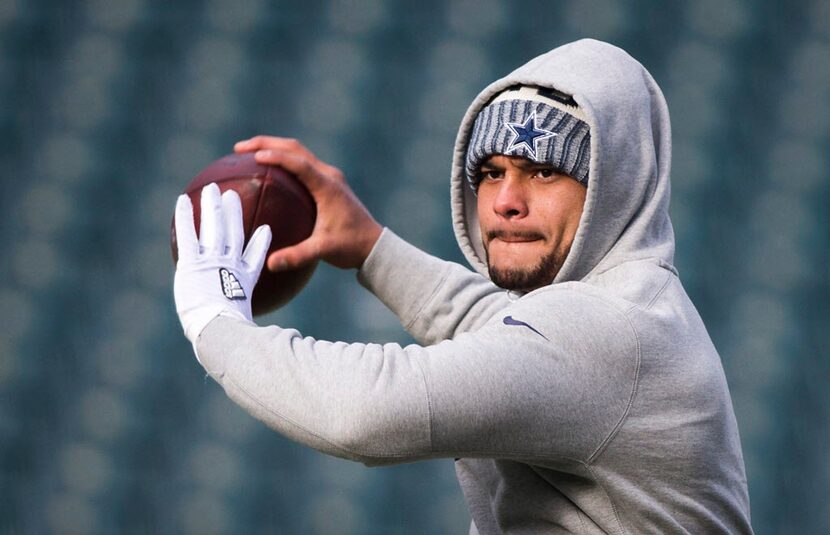 Dallas Cowboys quarterback Dak Prescott warms up before an NFL football game against the...