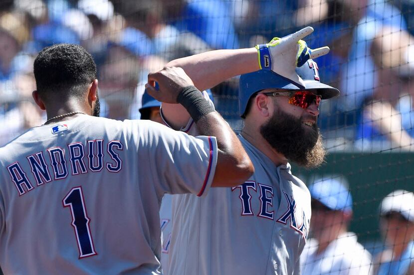 Texas Rangers' Mike Napoli is congratulated by Elvis Andrus after Napoli hit a solo home run...
