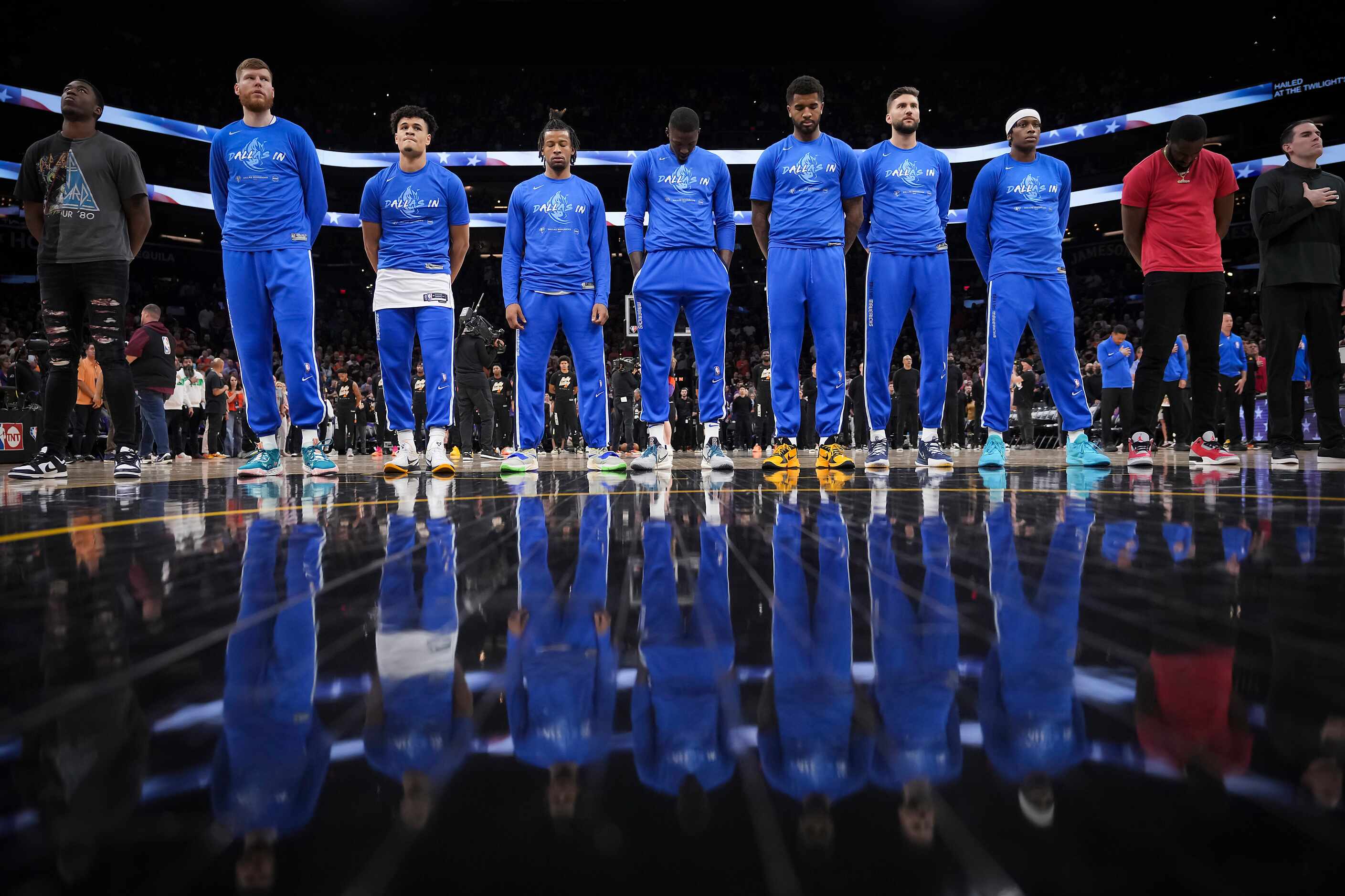 Dallas Mavericks players stand for the national anthem before Game 1 of an NBA second round...