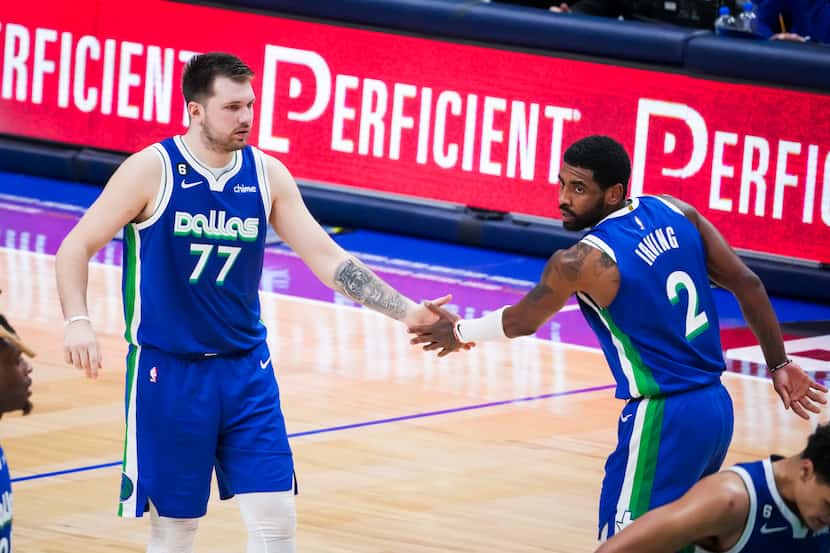 Dallas Mavericks guard Luka Doncic (77) celebrates with guard Kyrie Irving (2) after a...