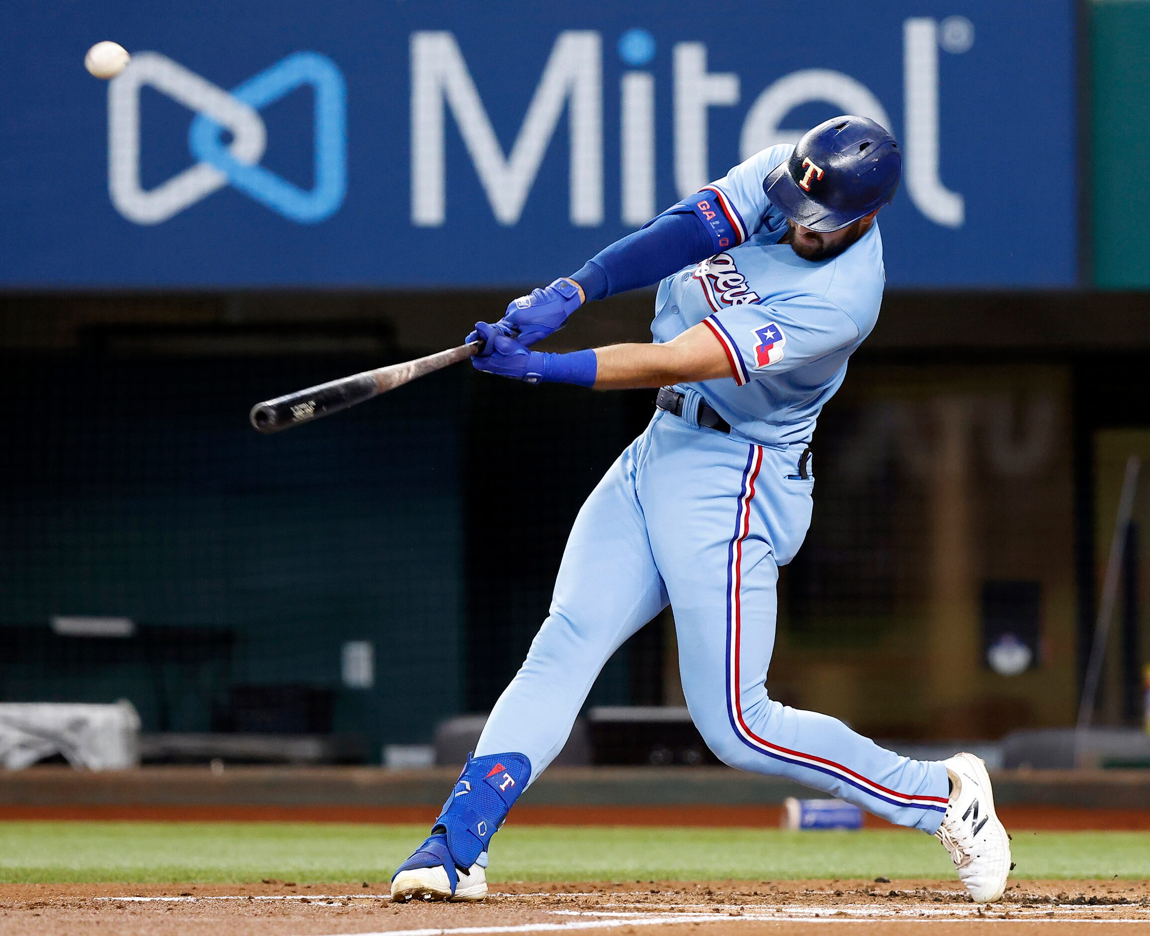 Texas Rangers batter Joey Gallo (13) connects on a two-run homer to left field in the first...