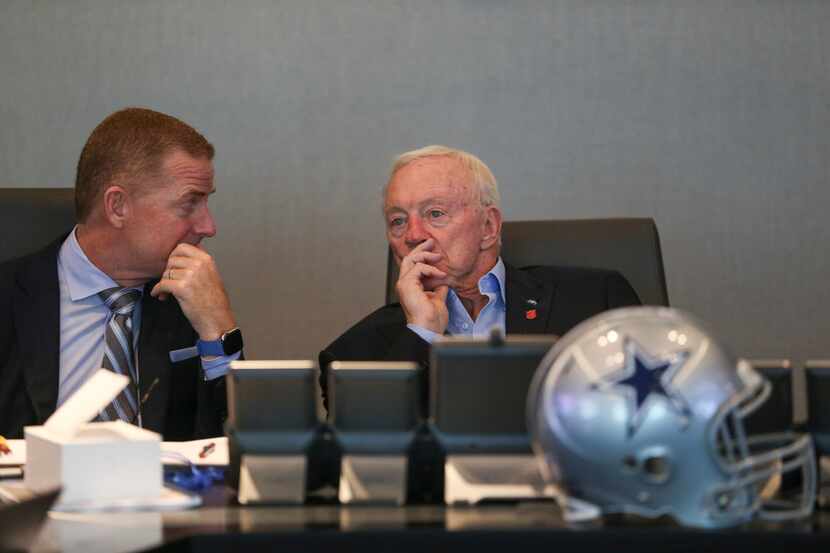 Dallas Cowboys Head Coach Jason Garrett, left, and Owner Jerry Jones, talk at head the table...