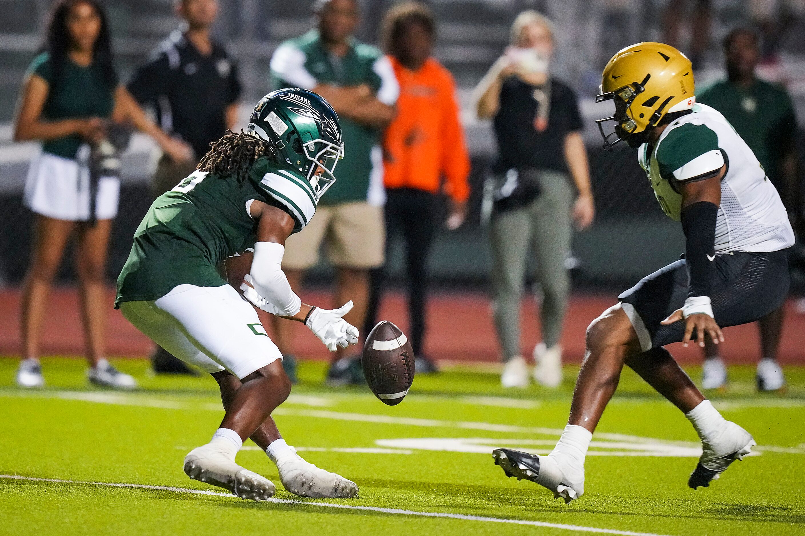 Waxahachie wide receiver Micah Cook (6) fumbles a punt return, turning the ball over to...