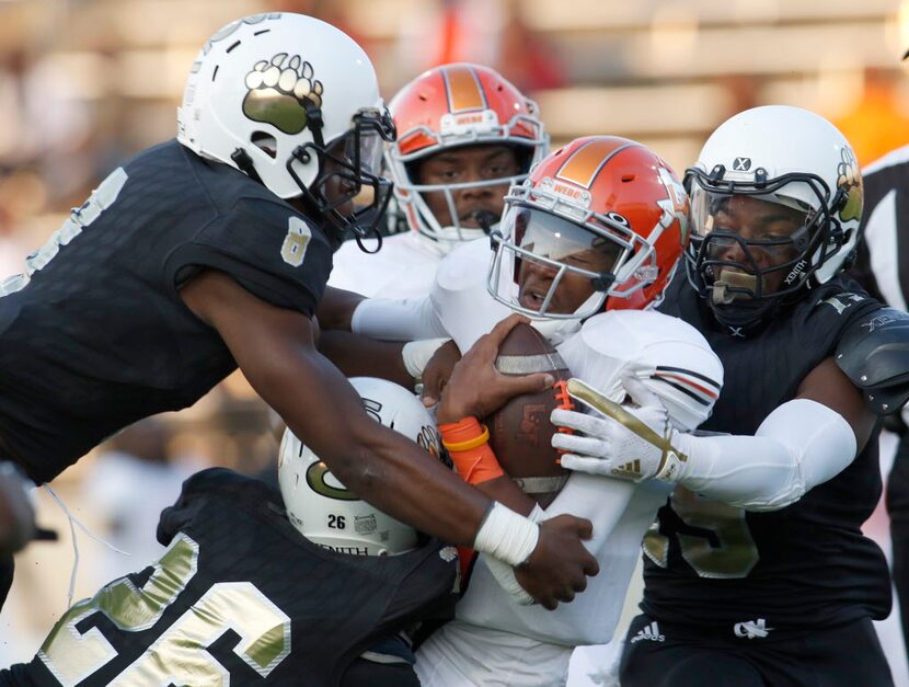 Lancaster quarterback Trevor Hatton (8) feels the heat of the South Oak Cliff defense after...