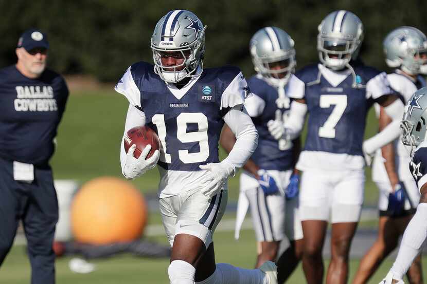 Cornerback Noah Igbinoghene (19) carries the football in a drill as the Dallas Cowboys held...