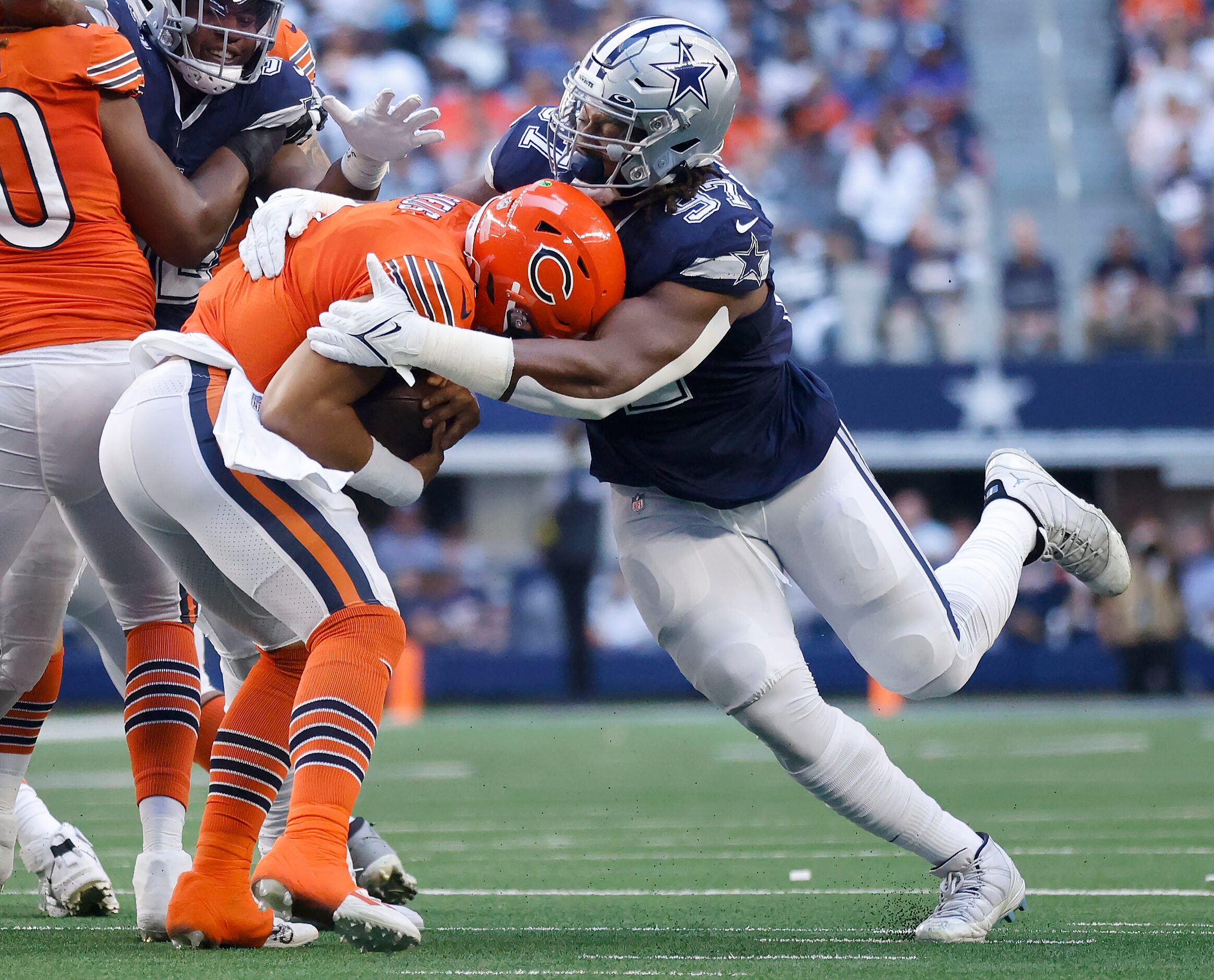 Dallas Cowboys defensive tackle Osa Odighizuwa (97) sacks Chicago Bears quarterback Justin...