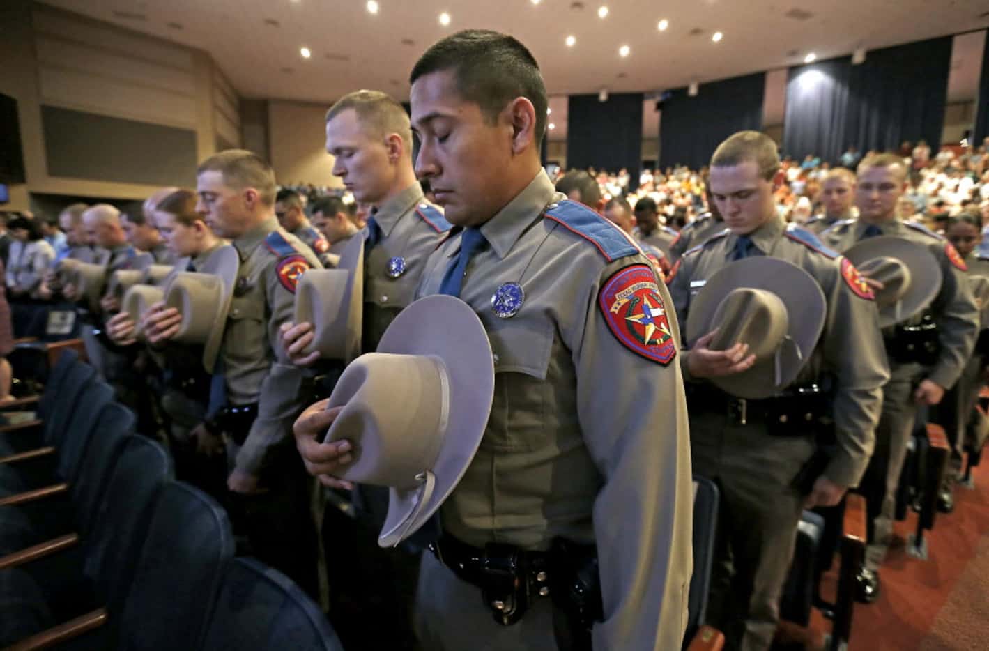 Members of the 155th trooper training class bow their heads during the Texas Department of...
