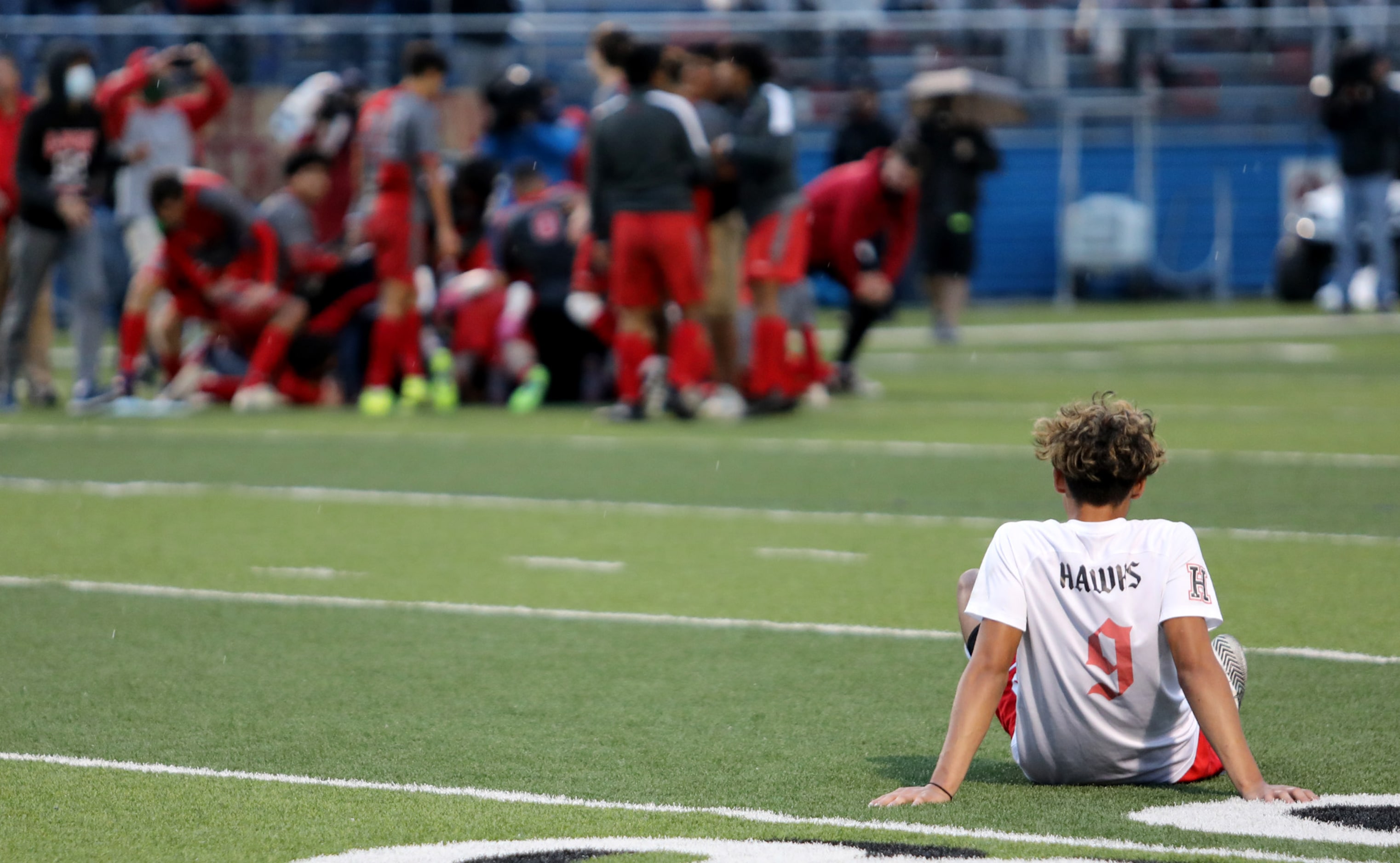 Rockwall-Heath's Chuy Ruiz (9) watches the SA Lee team celebrate after their UIL 6A boys...