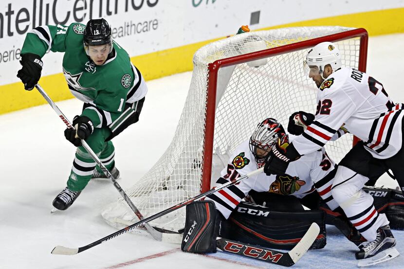 Chicago Blackhawks goalie Corey Crawford (50) and defenseman Michal Rozsival (32) block a...