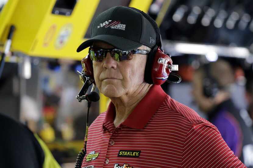 Team owner Joe Gibbs looks from the garage during practice for Saturday's NASCAR Sprint Cup...