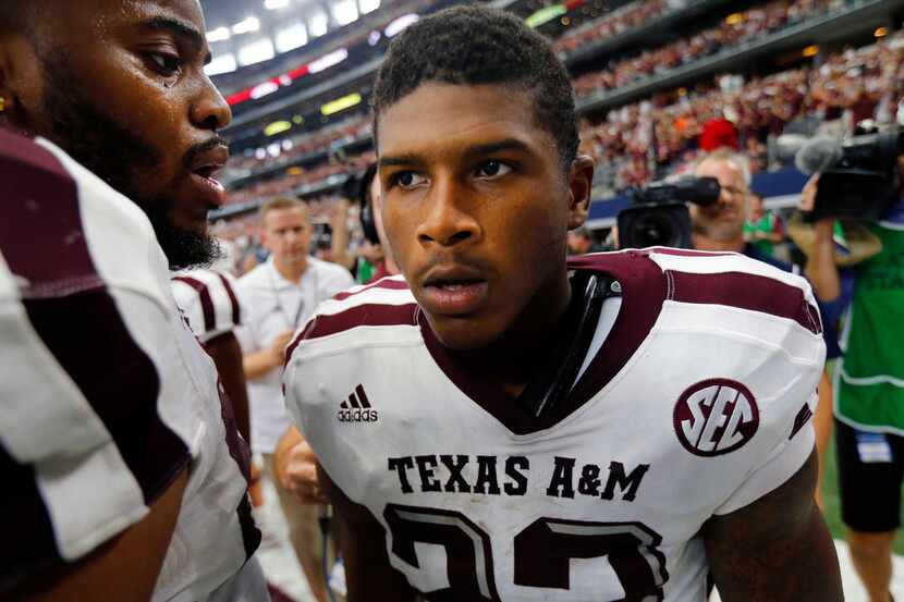 Texas A&M Aggies defensive back Armani Watts (23) is congratulated by teammates after...