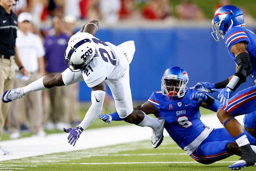 TCU Horned Frogs running back Kyle Hicks (21) flies through the air after being hit by...