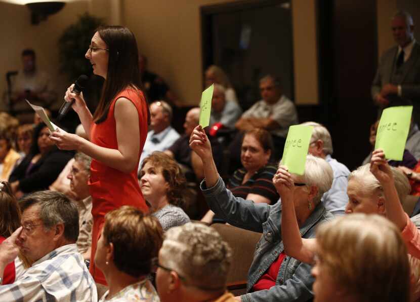 Lindsey Perkins asks a question during a town hall meeting held by Rep. Joe Barton,...
