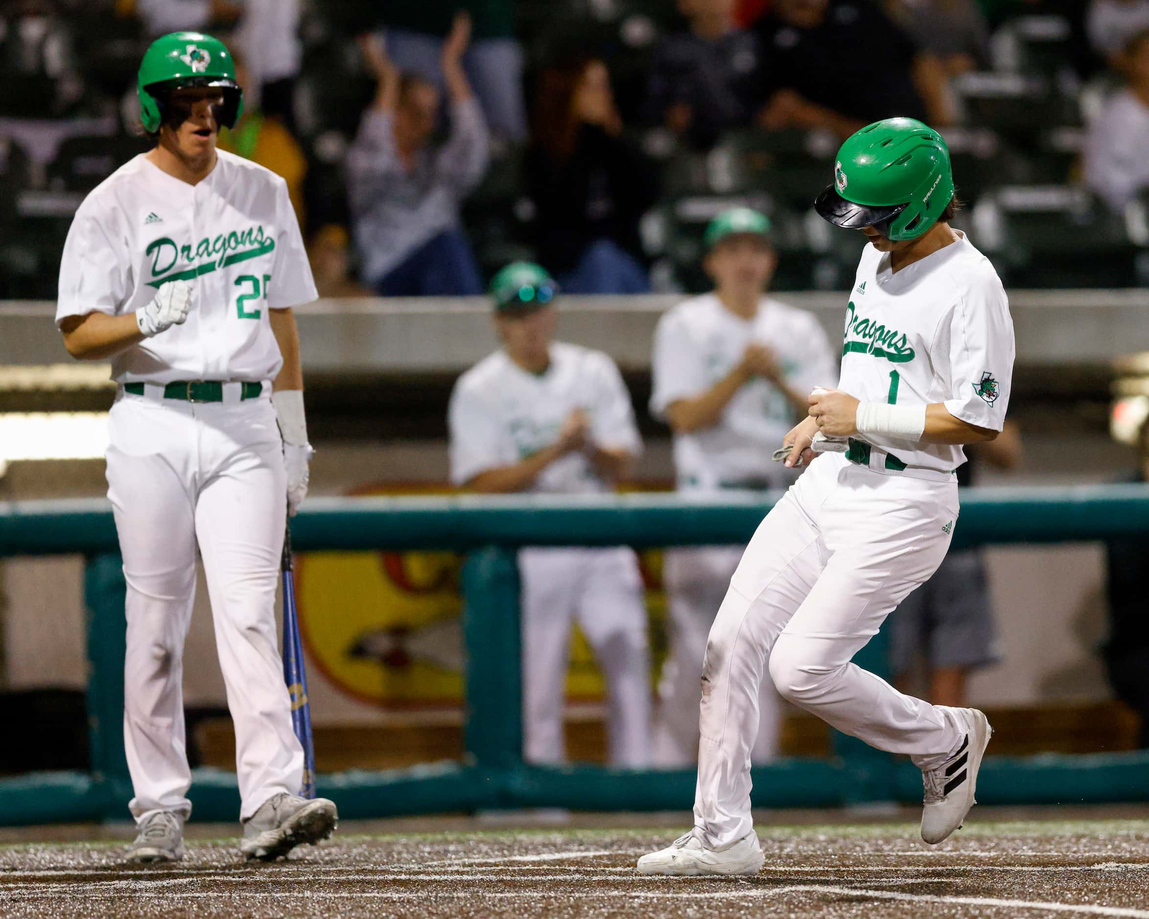 Southlake Carroll shortstop Ethan Mendoza (1) scores a run during the fourth inning of game...